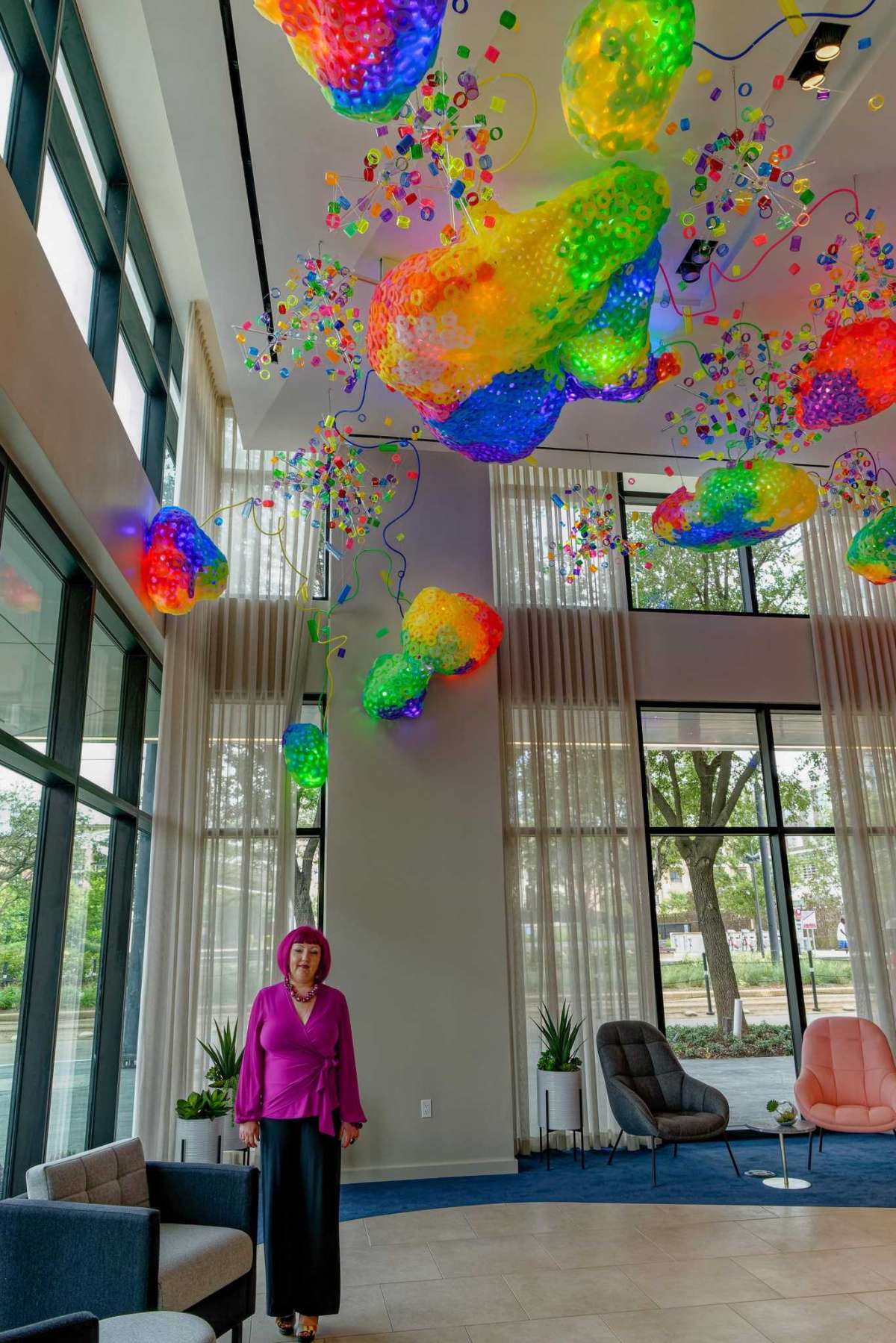 Houston artist Adela Andea poses below "The Great Barrier Reef," her permanent installation for the lobby of Drewery Place, a new highrise project of the Australian firm Caydon USA in Midtown.